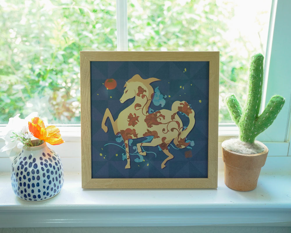 Framed artwork of a stylized horse on a windowsill with a cactus and vase.