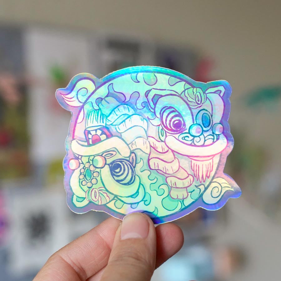Holographic Yin Yang Fut San Hok San Lion Dance Sticker held by fingers