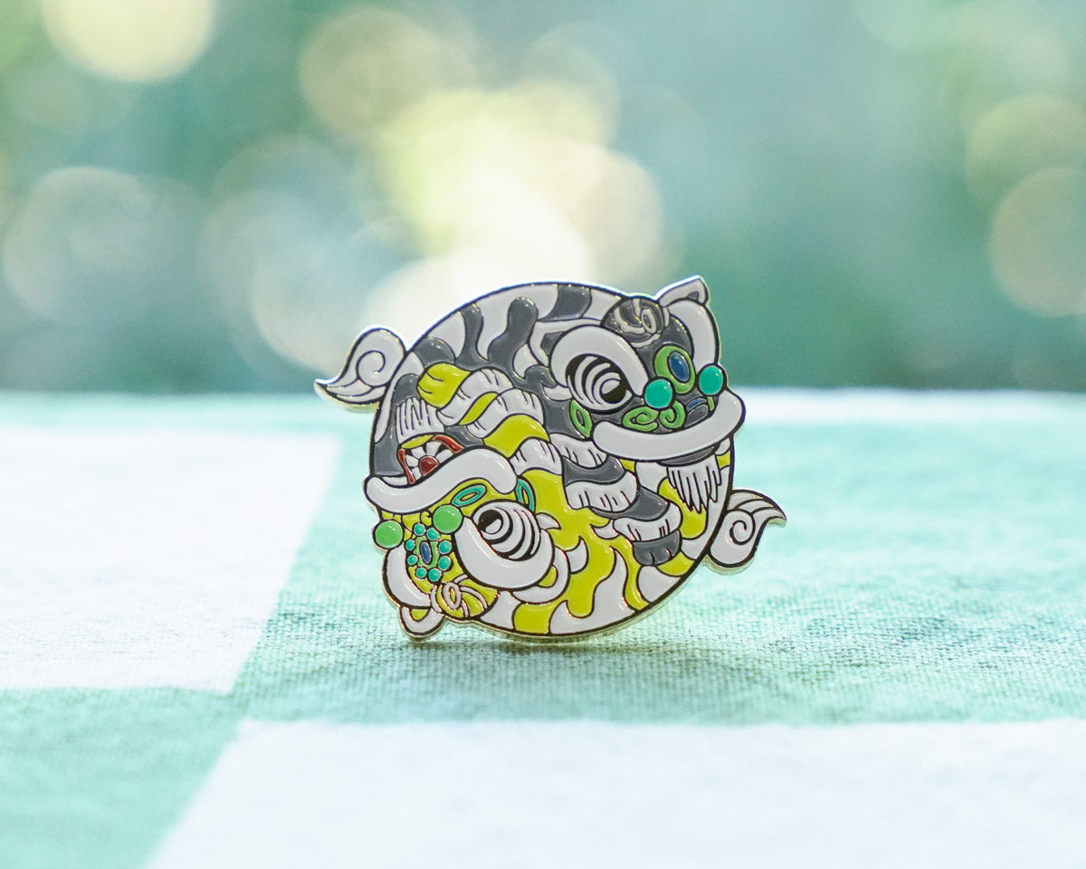 Colorful cartoon-style Chinese Lion pin on a light green background