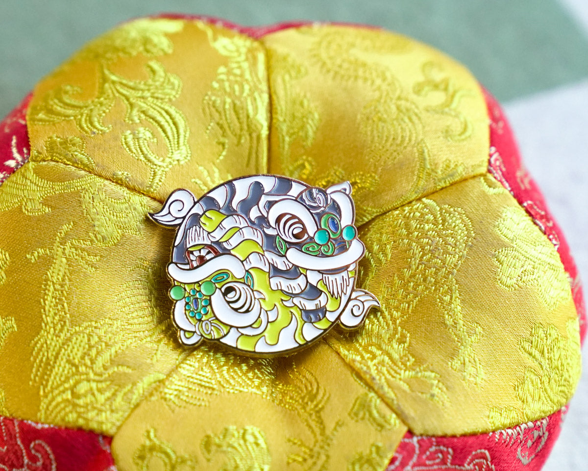 Decorative brooch on a yellow and red fabric background