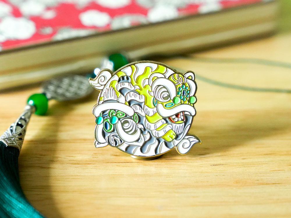 Decorative pin with cartoonish design on a wooden surface