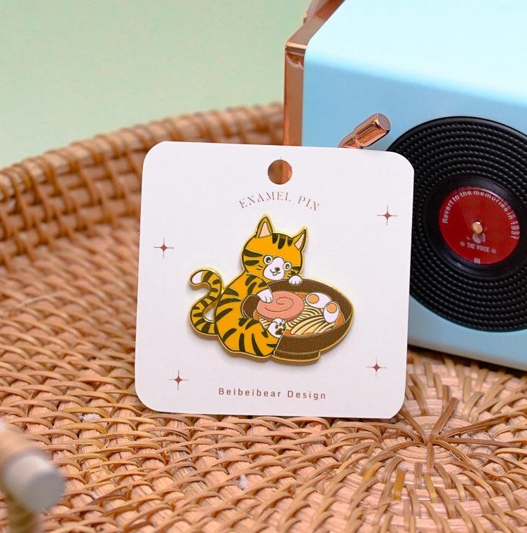 Ramen Cat Pin, Hard Enamel Pin of an Orange Tabby Cat Holding a Bowl of Ramen